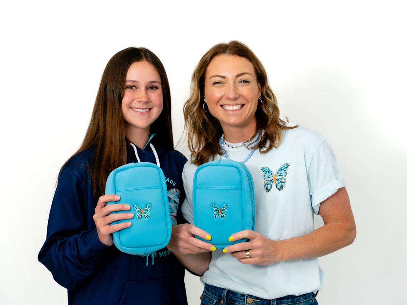 Meredith and a girl holding matching blue SLBs